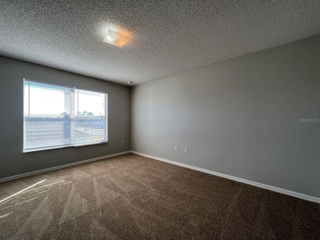 340 Cimarron Ct, Poinciana, FL 34759 - spare room featuring carpet flooring, a textured ceiling, and baseboards