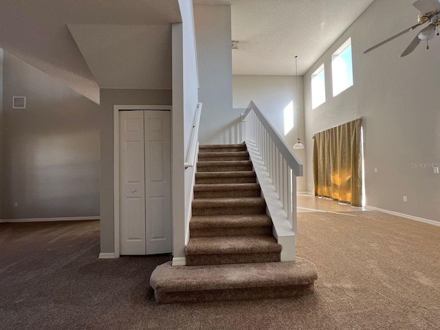 340 Cimarron Ct, Poinciana, FL 34759 - staircase featuring carpet floors, a ceiling fan, and baseboards