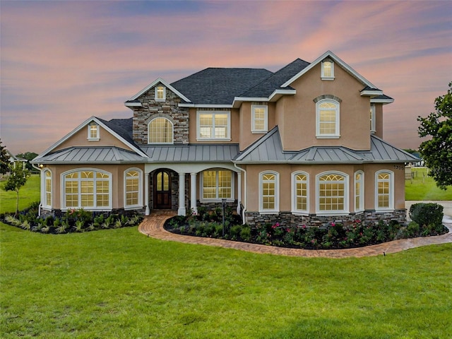2350 Bradbury Rd, Haines City, FL 33844 - view of front facade with a standing seam roof, a lawn, and stucco siding