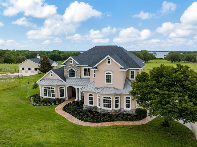 2350 Bradbury Rd, Haines City, FL 33844 - french country style house featuring a standing seam roof, stone siding, and stucco siding