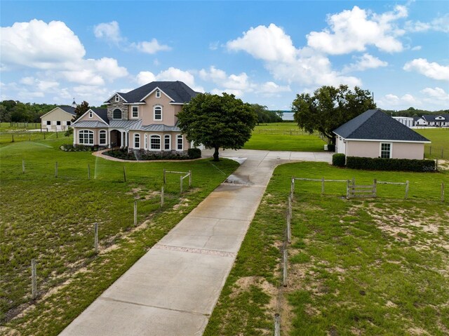 2350 Bradbury Rd, Haines City, FL 33844 - view of front of house with concrete driveway, a standing seam roof, and metal roof