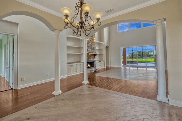 2350 Bradbury Rd, Haines City, FL 33844 - unfurnished dining area with built in features, wood-type flooring, baseboards, and crown molding