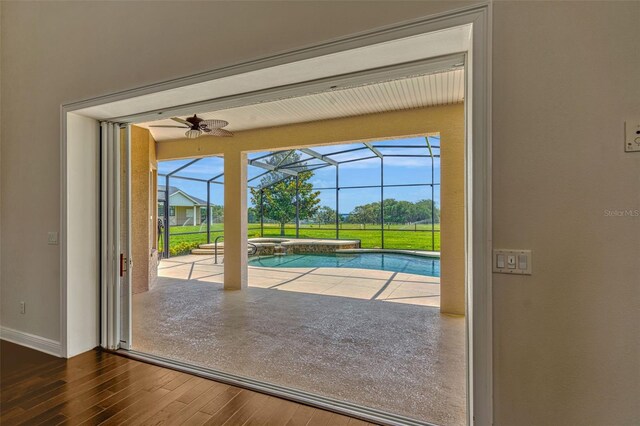 2350 Bradbury Rd, Haines City, FL 33844 - doorway to outside featuring a sunroom, wood finished floors, baseboards, and a ceiling fan