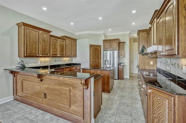2350 Bradbury Rd, Haines City, FL 33844 - kitchen with stainless steel refrigerator with ice dispenser, a peninsula, backsplash, dark stone countertops, and recessed lighting