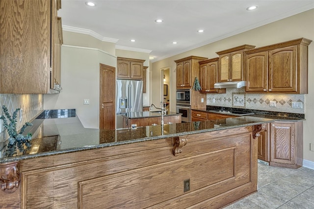 2350 Bradbury Rd, Haines City, FL 33844 - kitchen with appliances with stainless steel finishes, under cabinet range hood, a peninsula, tasteful backsplash, and ornamental molding