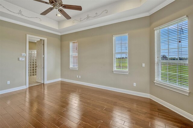 2350 Bradbury Rd, Haines City, FL 33844 - empty room featuring a raised ceiling, a ceiling fan, healthy amount of natural light, baseboards, and crown molding