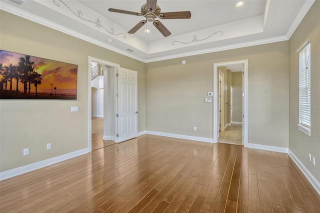 2350 Bradbury Rd, Haines City, FL 33844 - empty room featuring a raised ceiling, a ceiling fan, wood finished floors, ornamental molding, and baseboards