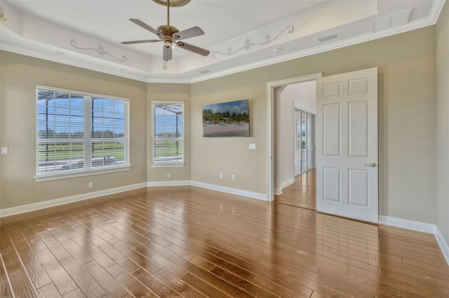 2350 Bradbury Rd, Haines City, FL 33844 - unfurnished room featuring ceiling fan, crown molding, a tray ceiling, wood finished floors, and baseboards