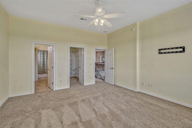 2350 Bradbury Rd, Haines City, FL 33844 - unfurnished bedroom with carpet, baseboards, a walk in closet, and ceiling fan