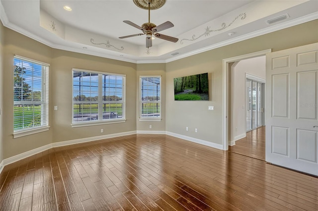 2350 Bradbury Rd, Haines City, FL 33844 - unfurnished room featuring ceiling fan, a tray ceiling, wood-type flooring, ornamental molding, and baseboards