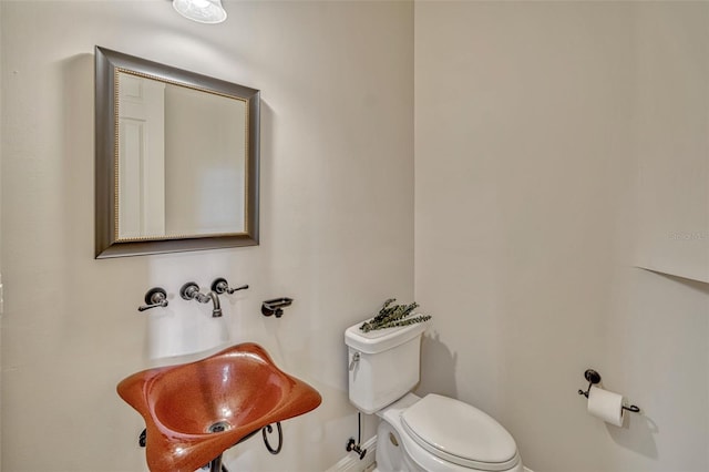 2350 Bradbury Rd, Haines City, FL 33844 - half bathroom featuring toilet and baseboards