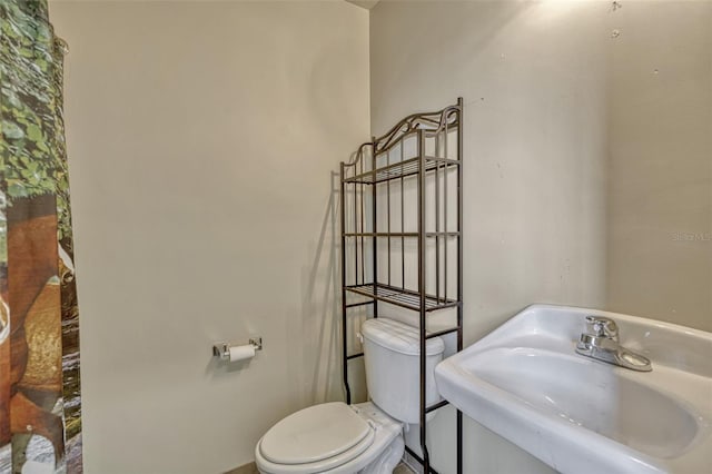2350 Bradbury Rd, Haines City, FL 33844 - bathroom featuring a sink, toilet, and baseboards