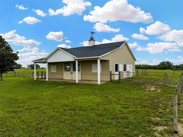 2350 Bradbury Rd, Haines City, FL 33844 - back of house featuring roof with shingles, a patio, and board and batten siding