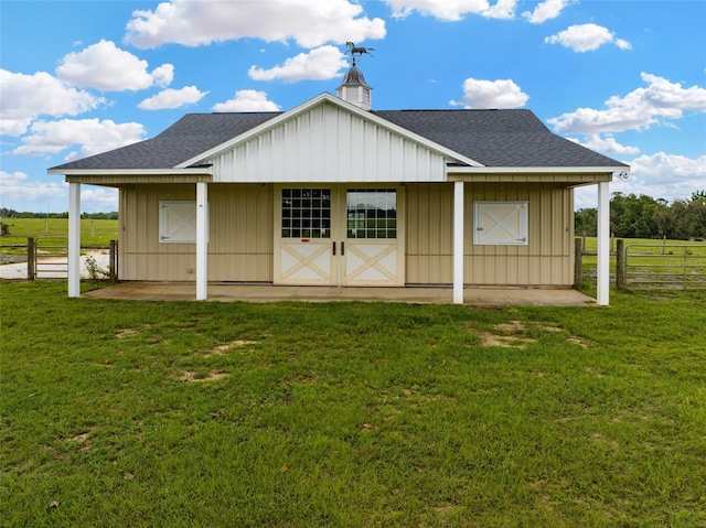 2350 Bradbury Rd, Haines City, FL 33844 - rear view of house featuring a shingled roof, board and batten siding, and a chimney