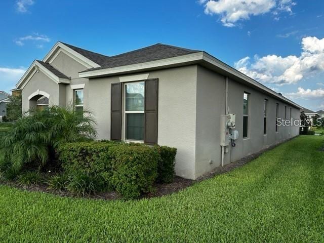 9318 Mclaren Aly, Winter Garden, FL 34787 - view of side of property with stucco siding and a lawn