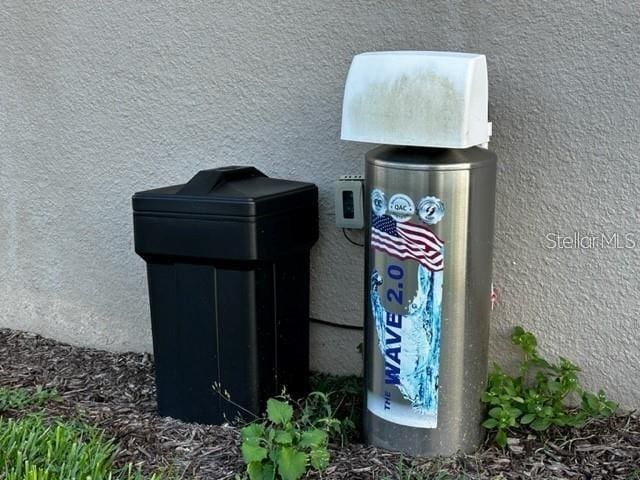 9318 Mclaren Aly, Winter Garden, FL 34787 - exterior view of stucco siding and a water softener system