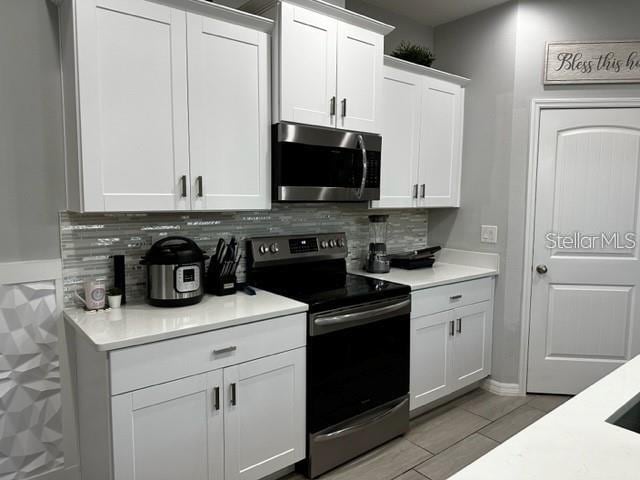 9318 Mclaren Aly, Winter Garden, FL 34787 - kitchen with stainless steel appliances, tasteful backsplash, and light countertops
