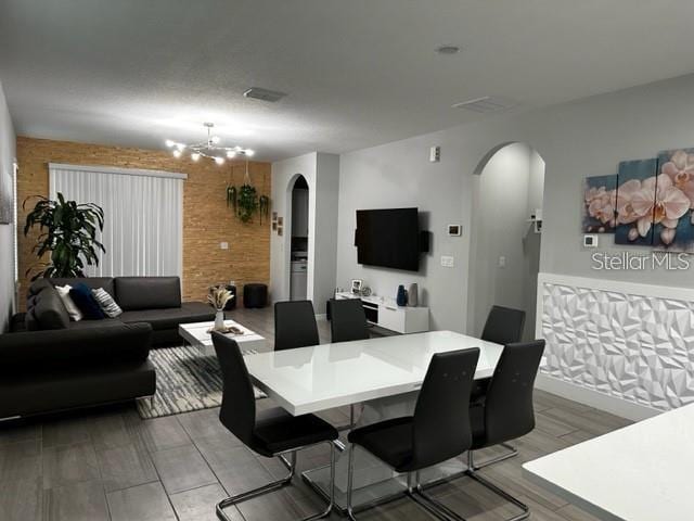 9318 Mclaren Aly, Winter Garden, FL 34787 - dining room featuring arched walkways and a chandelier