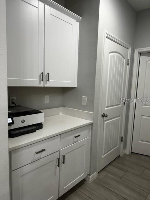 9318 Mclaren Aly, Winter Garden, FL 34787 - kitchen featuring white cabinets, light countertops, and dark wood-style floors