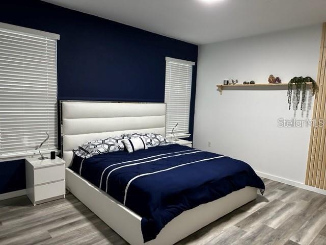 9318 Mclaren Aly, Winter Garden, FL 34787 - bedroom featuring light wood-style flooring and baseboards