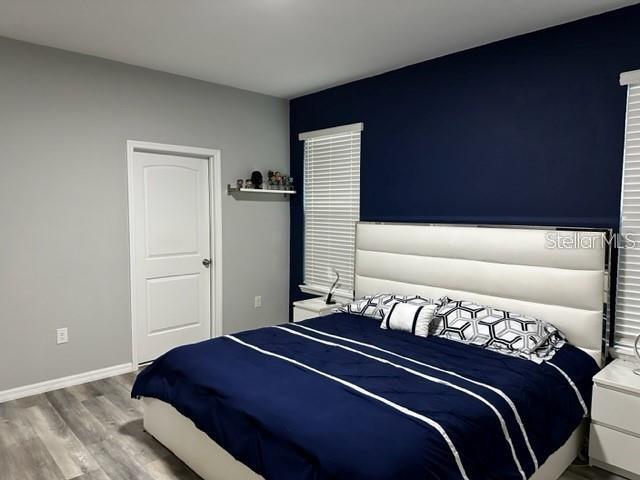 9318 Mclaren Aly, Winter Garden, FL 34787 - bedroom featuring wood finished floors and baseboards