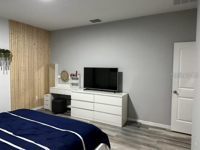 9318 Mclaren Aly, Winter Garden, FL 34787 - bedroom featuring light wood-style floors and baseboards