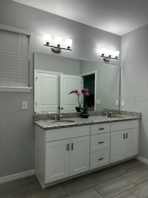9318 Mclaren Aly, Winter Garden, FL 34787 - bathroom with double vanity and baseboards