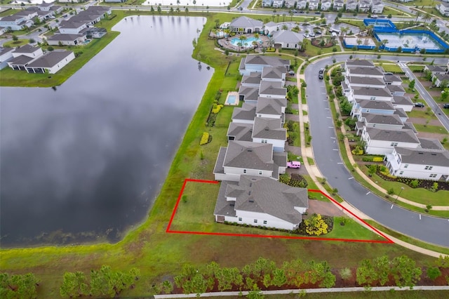 aerial perspective of suburban area featuring a nearby body of water and property parcel outlined