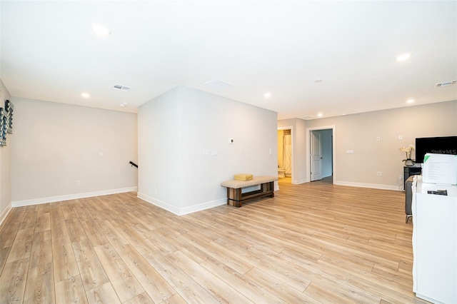 unfurnished living room with light wood-style floors, recessed lighting, and baseboards
