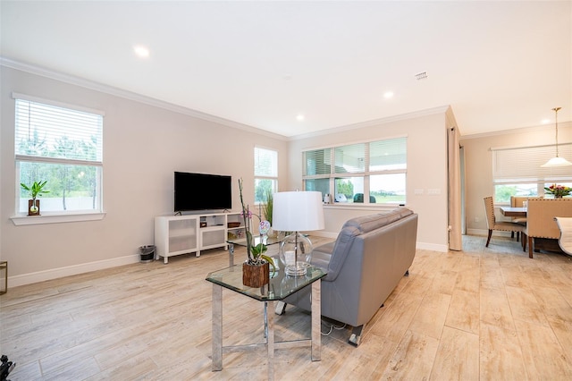 living area with ornamental molding, healthy amount of natural light, light wood-style floors, baseboards, and recessed lighting
