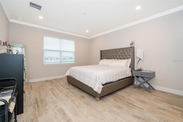 bedroom featuring ornamental molding, light wood-style flooring, baseboards, and recessed lighting