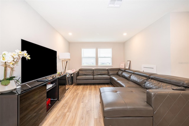 living room with light wood-type flooring and recessed lighting