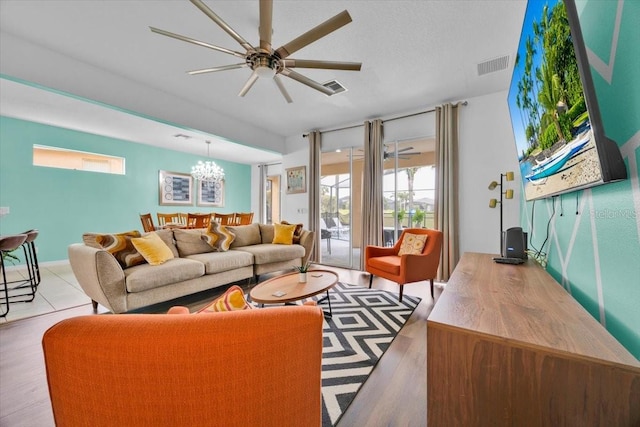 303 Plumoso Loop, Davenport, FL 33897 - living room with ceiling fan and a chandelier