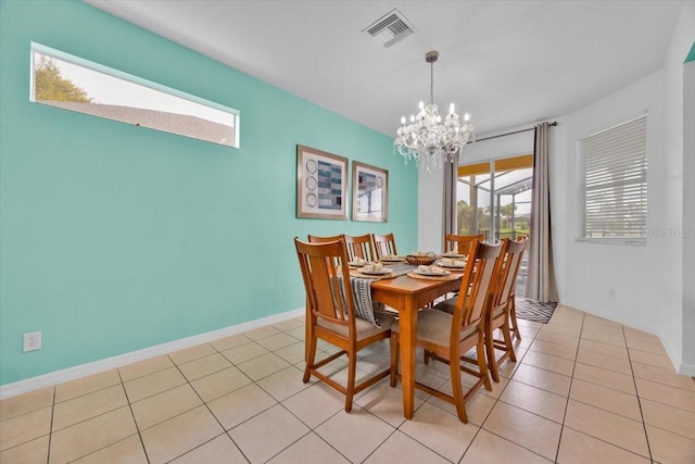 303 Plumoso Loop, Davenport, FL 33897 - dining area with a chandelier, baseboards, and light tile patterned floors