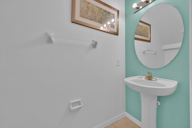 303 Plumoso Loop, Davenport, FL 33897 - bathroom with tile patterned floors, baseboards, and a sink