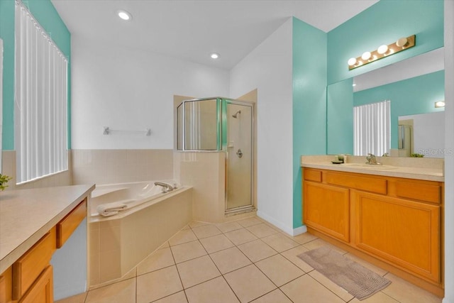 303 Plumoso Loop, Davenport, FL 33897 - full bath featuring a shower stall, tile patterned floors, a garden tub, and vanity
