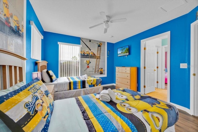 303 Plumoso Loop, Davenport, FL 33897 - bedroom featuring wood finished floors, ceiling fan, and baseboards