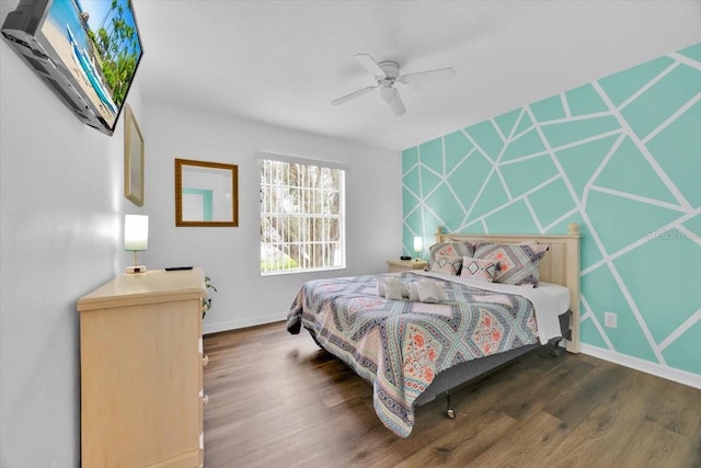 303 Plumoso Loop, Davenport, FL 33897 - bedroom with wood finished floors, baseboards, and ceiling fan