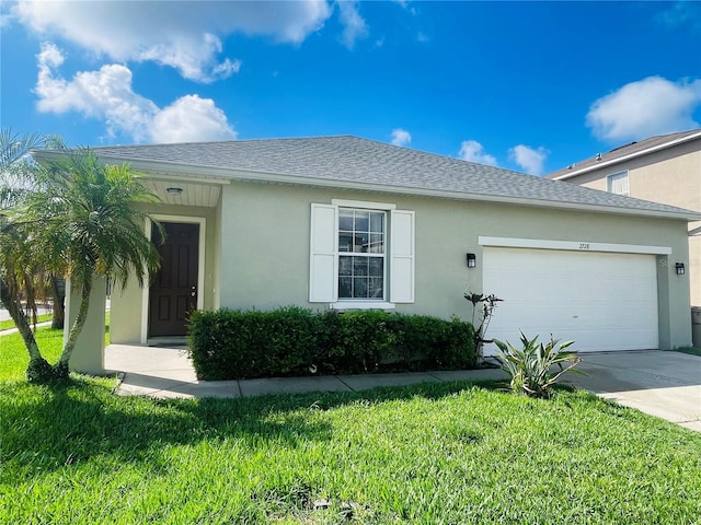 view of front of property with stucco siding, an attached garage, a front lawn, and driveway