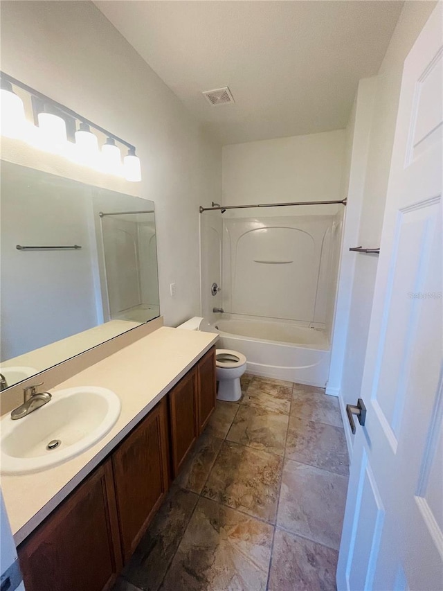 full bathroom with vanity, shower / bathtub combination, toilet, and stone finish flooring