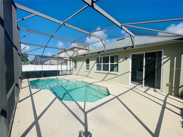 view of pool with a patio and a lanai
