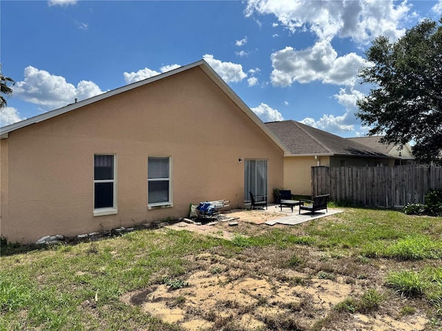 back of property featuring stucco siding and a patio area