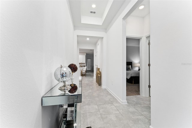 hallway featuring recessed lighting, light tile patterned floors, and baseboards
