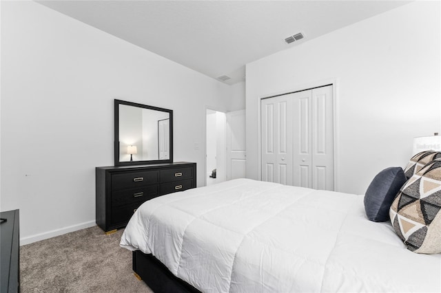 bedroom featuring carpet, a closet, and baseboards