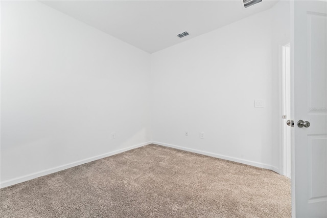 carpeted empty room featuring baseboards and lofted ceiling
