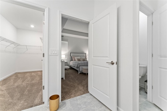 walk in closet featuring light colored carpet