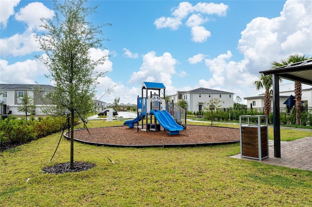 communal playground featuring a residential view