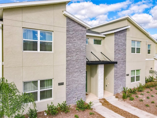 2970 Protagonist St, Kissimmee, FL 34746 - view of front of house with stone siding and stucco siding