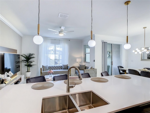 2970 Protagonist St, Kissimmee, FL 34746 - kitchen with a sink, open floor plan, light countertops, a ceiling fan, and hanging light fixtures