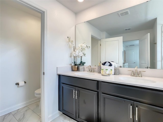 2970 Protagonist St, Kissimmee, FL 34746 - full bath featuring toilet, marble look tile flooring, baseboards, and double vanity